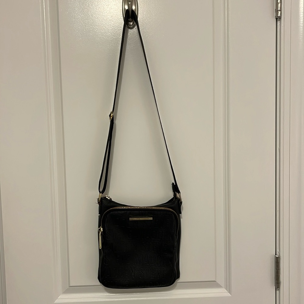 Black Steve Madden cross over bag with multiple compartments